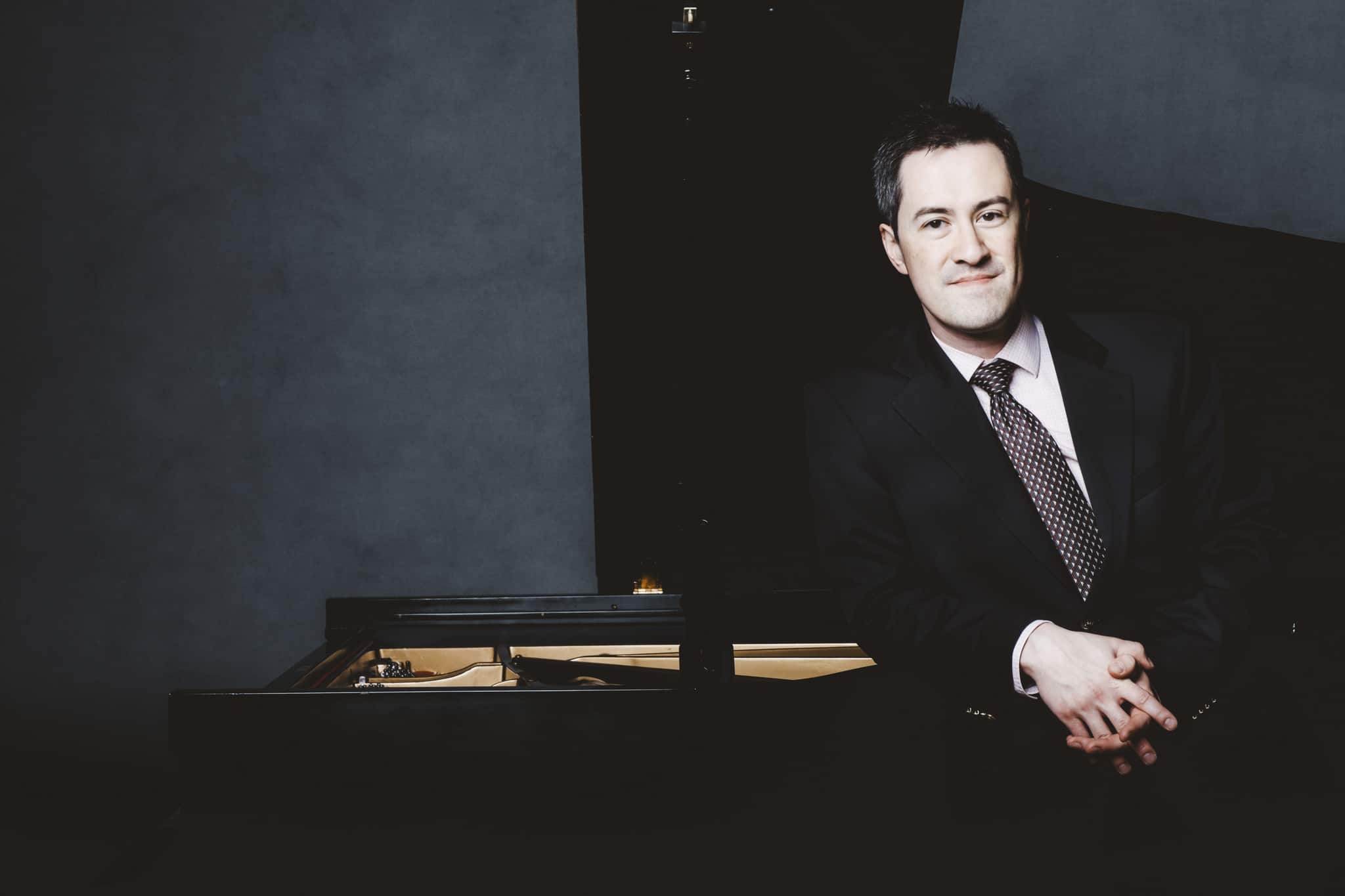 Andrew Brownell next to piano